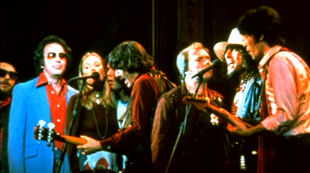 The Band con gli ospiti canta I Shall Be Released nel concerto d'addio The Last Waltz. Da sinistra a destra si riconoscono  Dr. John (parzialmente coperto), Neil Diamond, Joni Mitchell, Neil Young (parzialmente coperto), Rick Danko, Van Morrison, Bob Dylan e Robbie Robertson.