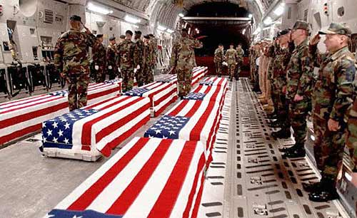 Caskets bearing U.S. soldiers are unloaded after a flight from the Middle East to Dover Air Force Base in Dover, Del.